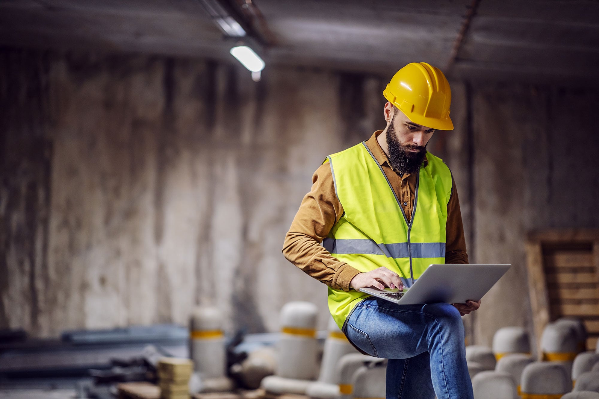 A contractor working on a laptop at the jobsite