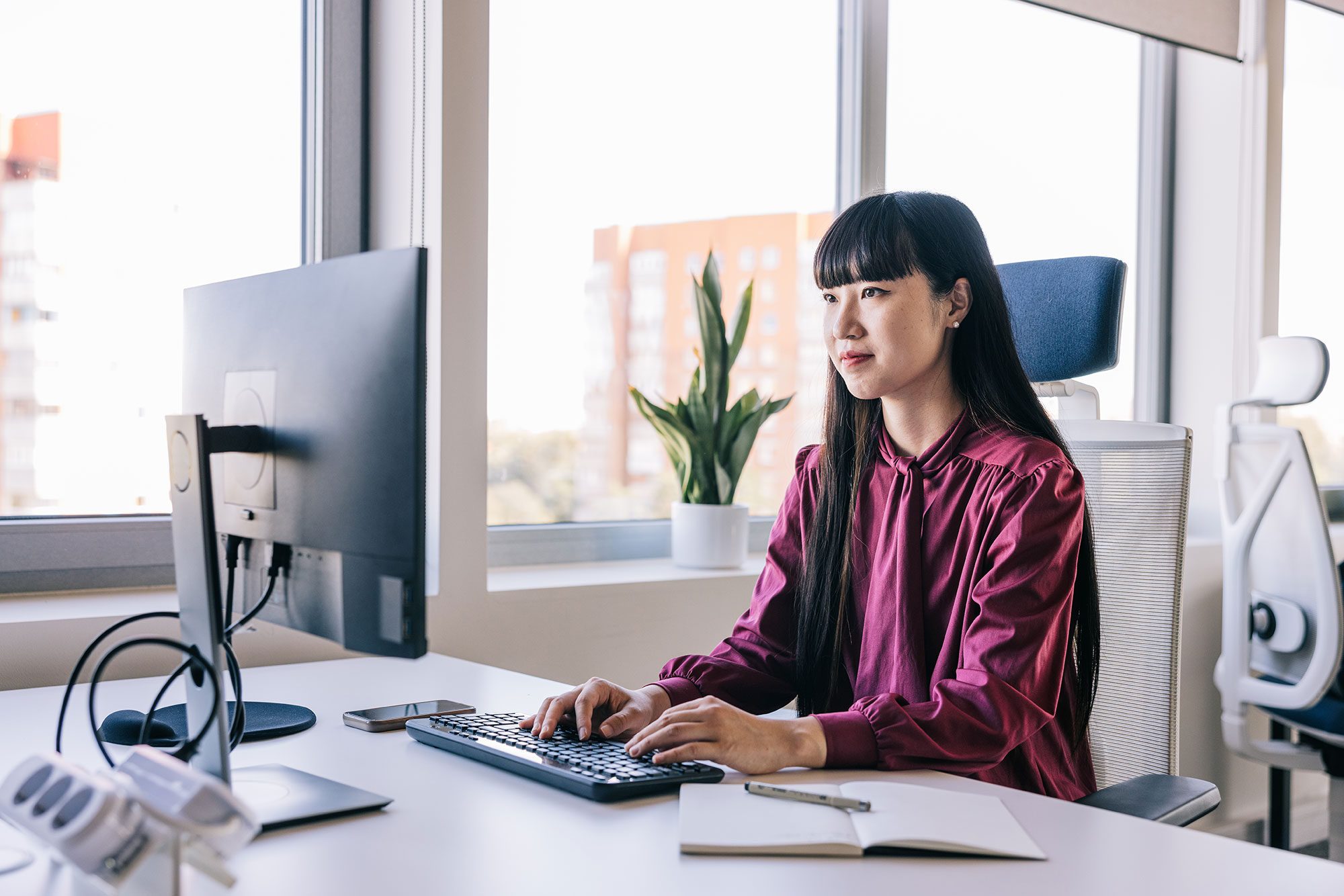 A claims professional reviewing a claim at a desk